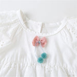 Baby Girl Cotton Romper Dress With Matching Hat – Soft, Breathable, Floral Design, Easy Diaper Access with bow and pompom detail close-up