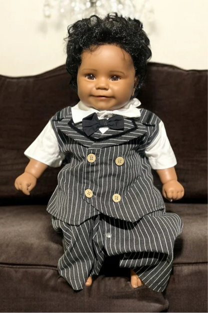 A charming black baby doll dressed in a pinstripe suit and bow tie, embodying the essence of a little gentleman.