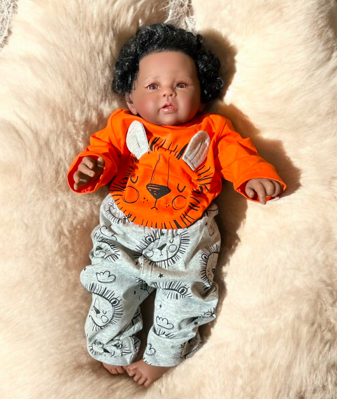 Cute unisex orange baby outfit with a charming lion graphic, ideal for your little cub's wardrobe and playful adventures.