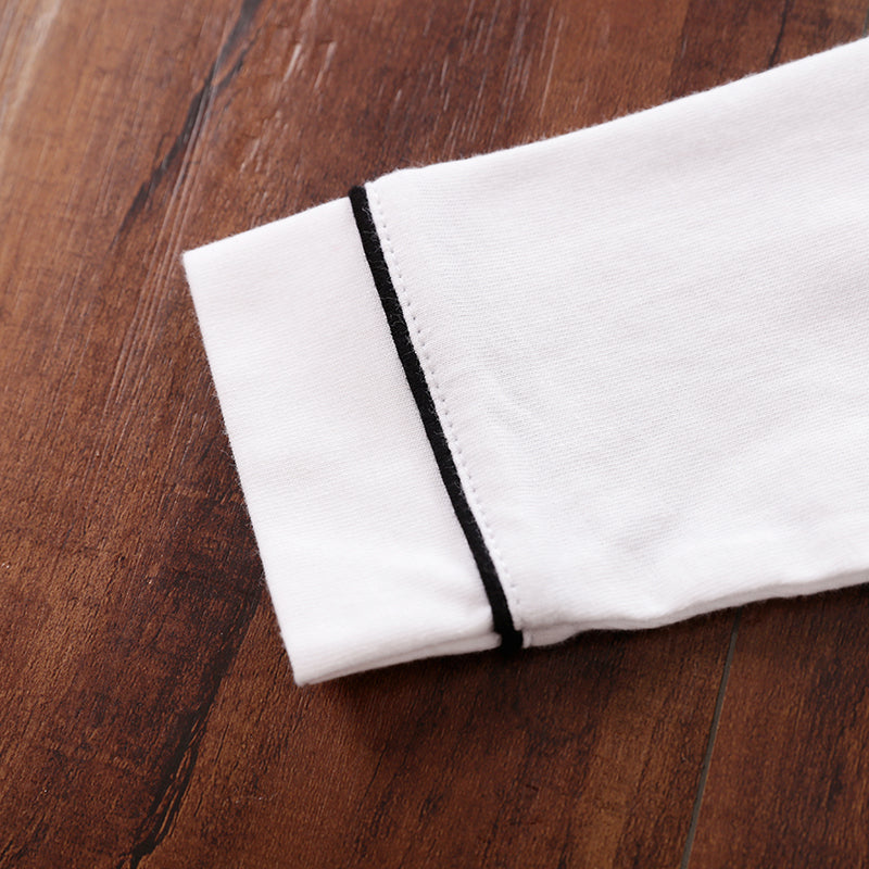 White fabric with black trim on a wooden surface