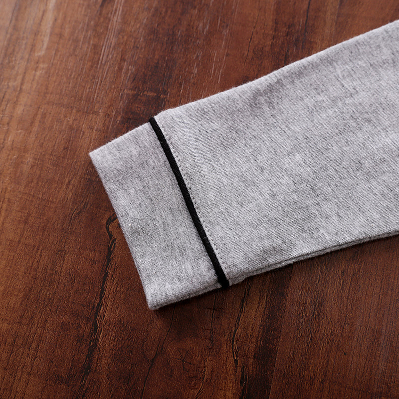 Gray cotton fabric with a black stripe on a wooden surface