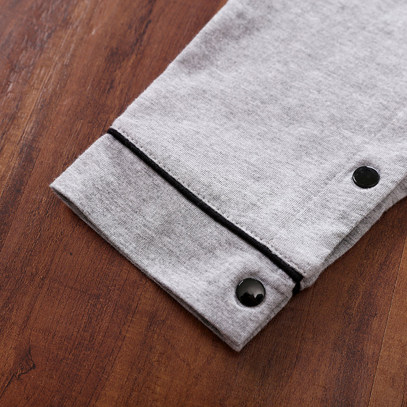 Gray fabric with black snap buttons on a wooden surface