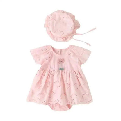 Sweet baby girl dressed in a pink cotton romper and hat, embodying playful elegance and joy.